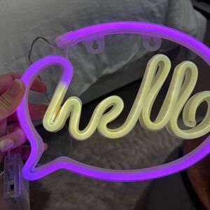 Purple and White Neon 'Hello' Sign
